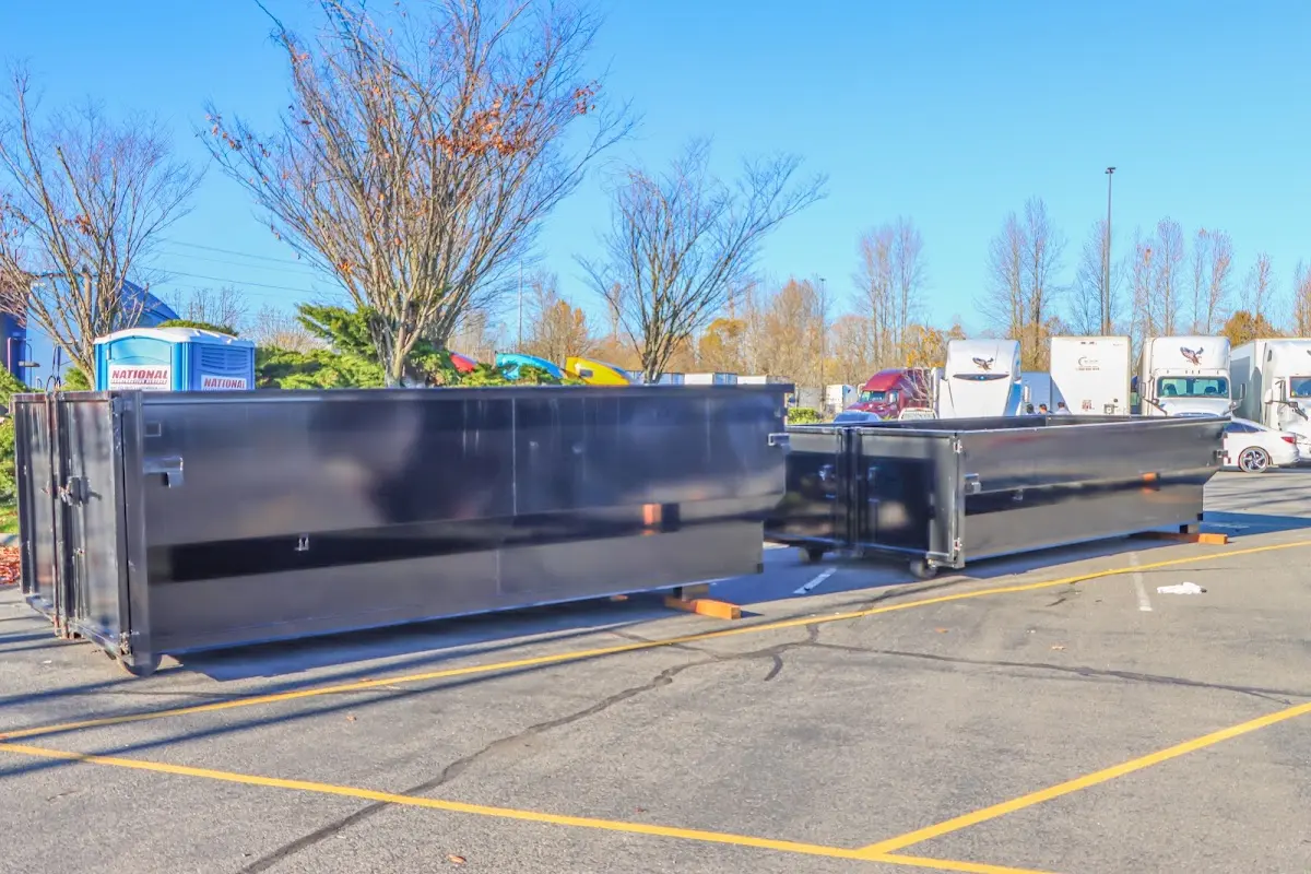 Professional dumpster rental service with roll-off container on residential driveway in Stuarts Draft
